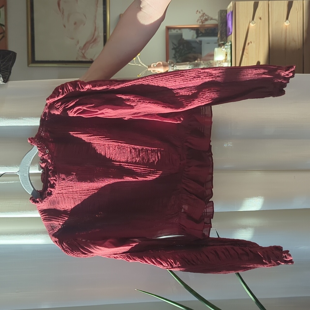 Doen maroon blouse with lace, ruffle, and pleat detail.